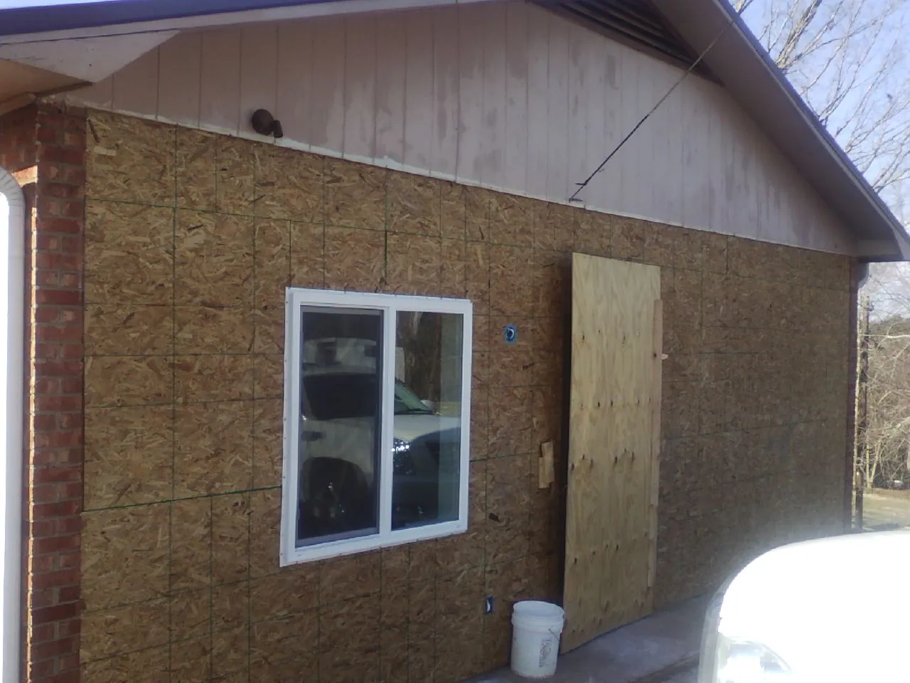 OSB sheathing on a garage addition wall before siding in Eastport
